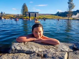girl enjoying secret lagoon geothermal nature bath